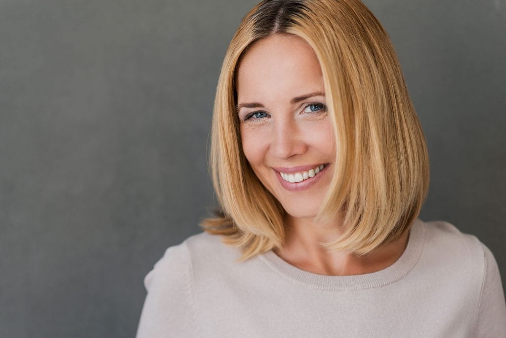 Woman smiling after a deep plane facelift in Lafayette for facial rejuvenation