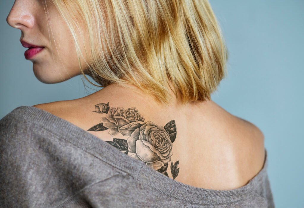 Young blonde woman with fresh back tattoo