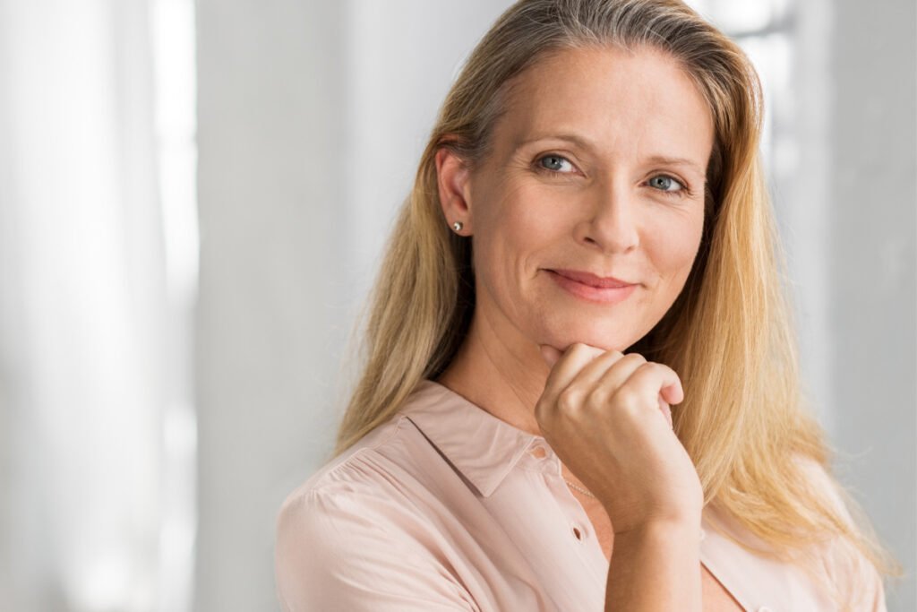 Senior woman thinking with hand on chin