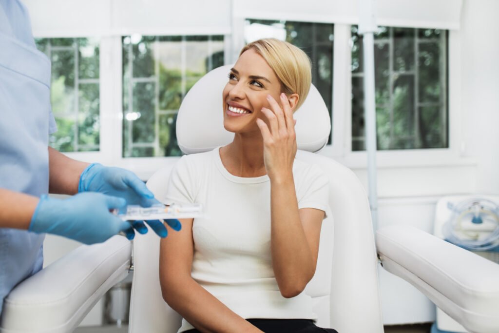 Woman at a med spa discussing filler touch up treatment with her injector