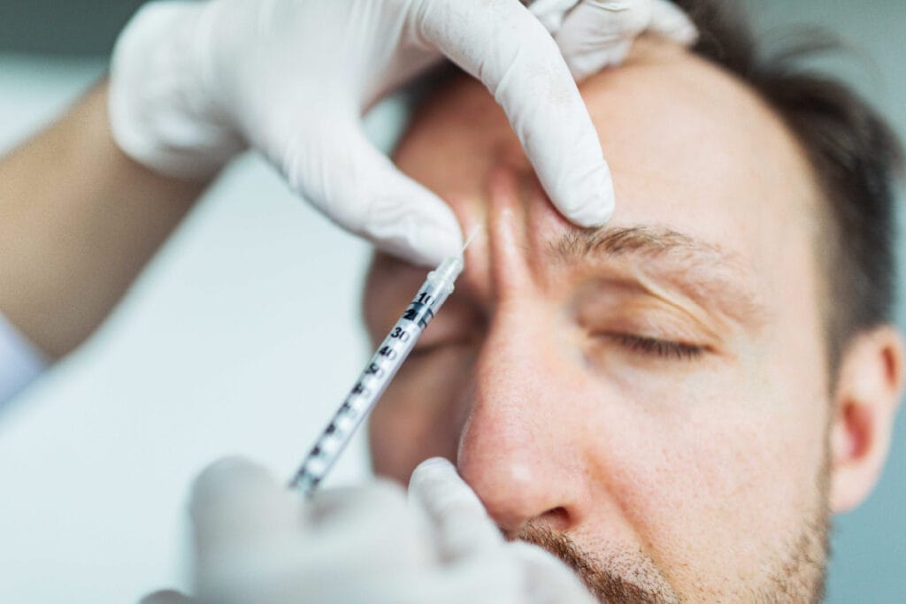 Man getting Jeuveau injections for frown lines